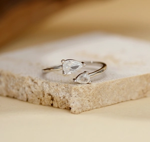 Detailed macro view of S925 silver open ring featuring dual pear-cut cubic zirconia stones