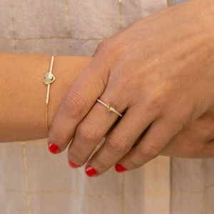 Close-up of gold heart-shaped ring and bracelet set with sparkling pavé cubic zirconia