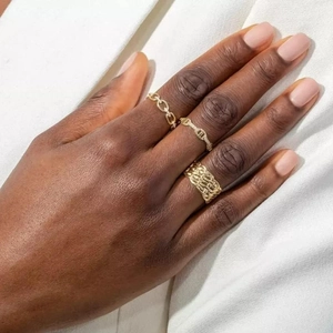 Three-piece gold ring set featuring cuban link, pave diamonds, and braided textures
