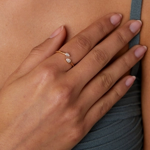 Elegant gold S925 silver open ring with double pear-shaped cubic zirconia stones on a finger