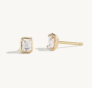 Detailed view of square-cut cubic zirconia studs with polished 925 silver four-prong setting