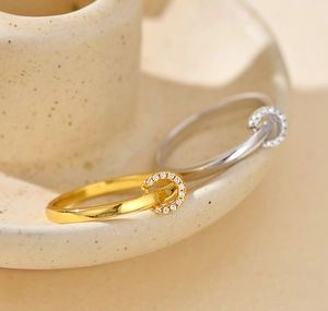 Detailed side view of silver and gold rings with micro-pave horseshoe design