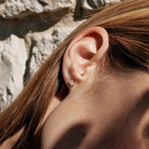 Elegant S925 silver square zircon stud earrings worn by a model in natural sunlight