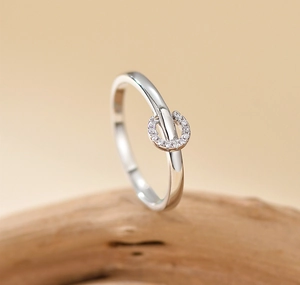 Macro shot of S925 silver ring featuring interlocking loops with micro-pave white zircons