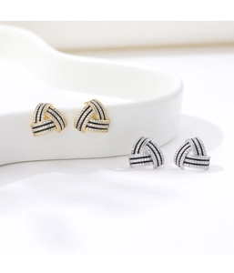 Macro detail of S925 sterling silver triangle stud earrings with micro pavé zircons