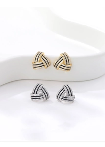 Macro detail of geometric triangle earrings with pave crystals and black contrast lines