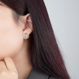 Close-up of S925 silver triangular earrings with black and white pavé cubic zirconia