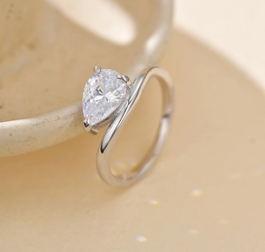 Macro shot of S925 silver ring featuring a pear-cut zircon in an elegant wrap design