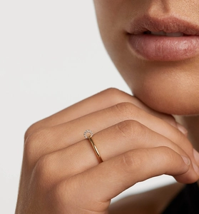 Close-up of a delicate gold plated S925 silver ring with micro-pave diamond loop on finger