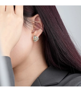Close-up of geometric S925 silver triangle earrings with black glaze and cubic zirconia