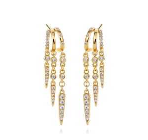 Detail of gold fringe drop earrings with triple chains and crystal-studded spikes