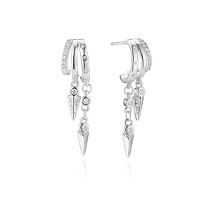Macro detail of silver-tone layered earrings with cubic zirconia and spike drop