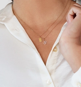 Close-up of S925 silver double layer necklace with gold plate and paved letter B charm