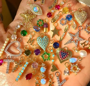 Macro shot of assorted S925 silver charms with colorful zircon and pearl details