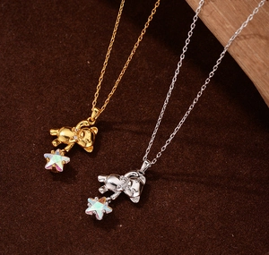 Detailed close-up of S925 silver teddy bear pendants with iridescent stars in gold and silver