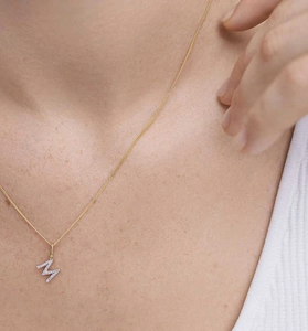 Close-up of a gold-plated S925 sterling silver letter W pendant with pavé diamonds