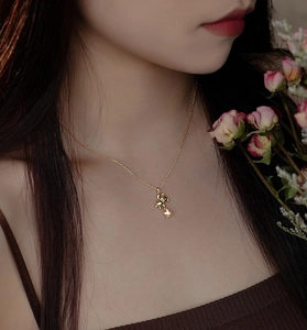 Detail of 925 silver golden bear pendant with sparkling star on a delicate chain