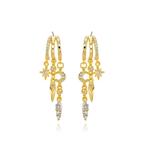 Macro shot of 18K gold-plated drop earrings featuring pavé star and moon charms with zircons