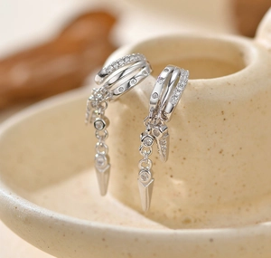 Macro view of S925 silver double layer stud earrings with cubic zirconia and rivets