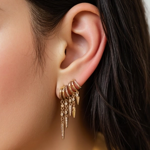 Gold tassel drop earrings with sparkling crystals and punk style geometric rivets