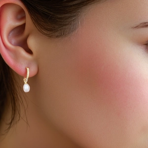 Elegant gold huggie hoop earrings with oval pearl drops and pave-set zircons for women
