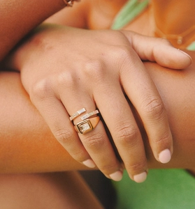 Detail of stacked s925 silver gold rings with emerald cut diamonds on hand