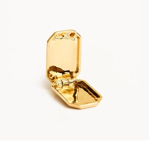 Detail of a golden rectangular locket pendant with a hinged opening mechanism and mirror finish