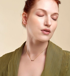 Close-up of a s925 silver gold necklace with colorful zircon pendant on model
