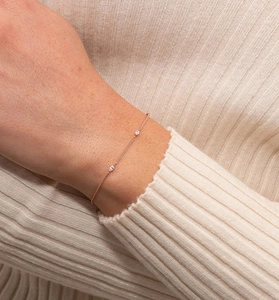 Close-up of elegant rose gold bracelet with marquise cut stones worn on wrist