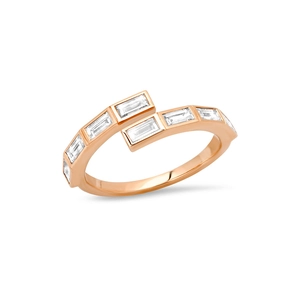 Macro detail of rose gold bypass ring with baguette cut crystals and polished finish