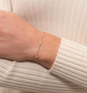 Macro shot of a minimalist silver chain bracelet featuring marquise-cut zircon stones