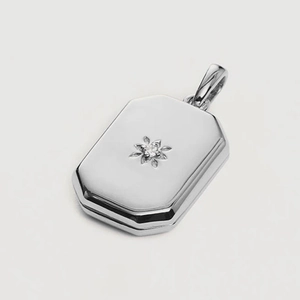 Silver octagonal locket necklace with engraved starburst and central gemstone detail