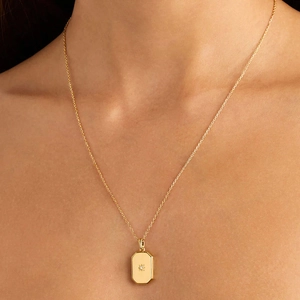 Minimalist gold square starburst locket necklace with zircon stone on model
