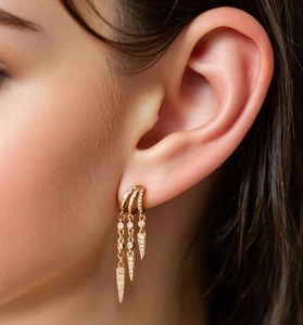 Macro view of gold-plated triple hoop earrings with spiked fringes and zircons
