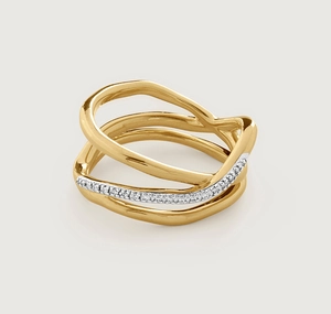 Macro shot of silver and gold interlaced ring featuring sparkling pavé diamond settings