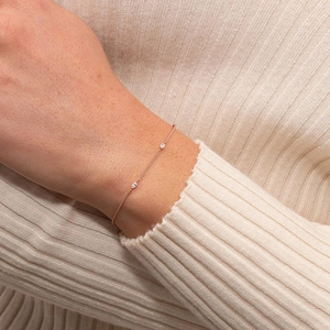 Elegant rose gold minimalist bracelet with two drop-shaped zircons on a delicate chain