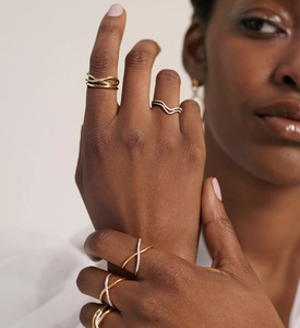 Close-up of three-layer cross design S925 silver rings with pavé cubic zirconia on hand