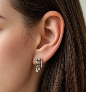 Close-up of S925 silver fringe earrings with sparkling zircons on a female model