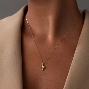 Minimalist S925 sterling silver heart pendant necklace with polished gold finish on model