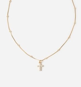 Close-up of a gold satellite chain necklace featuring a white pearl cross pendant