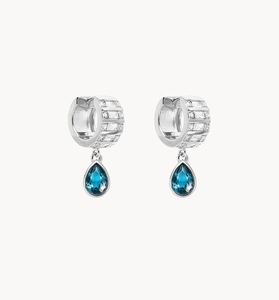Macro detail of S925 silver hoop earrings with zircon and deep blue teardrop gems