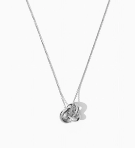 Close-up of polished S925 sterling silver interlocking triple ring knot necklace pendant