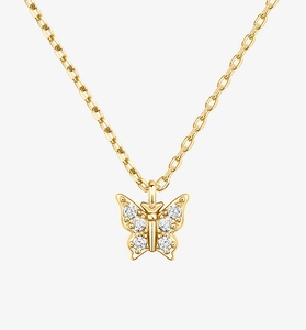 Macro shot of gold butterfly pendant necklace with sparkling diamonds on a white background