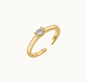 Detailed close-up of a gold-plated open ring featuring a sparkling solitaire tension setting