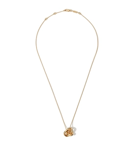 Macro detail of intertwined gold rings pendant with delicate chain and lobster clasp