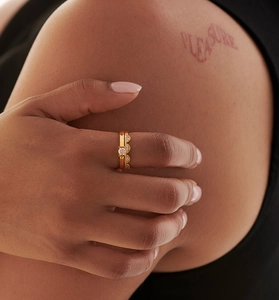 Close-up of a S925 sterling silver gold ring set with a round diamond and pavé band