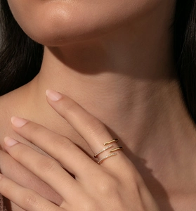 Detailed view of a gold triple-layer wrap ring with sparkling zircon pavé on a model hand