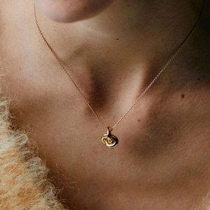 Elegant gold S925 sterling silver interlocking rings necklace on a female model