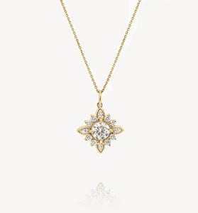 Macro view of gold S925 sterling silver starburst necklace with marquise-cut gems