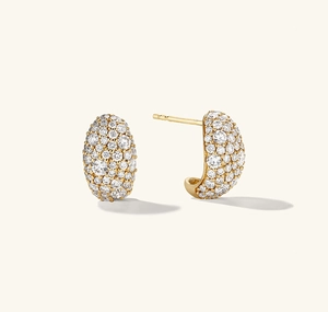 Macro shot of gold pavé hoop earrings with shimmering round-cut zircon stones